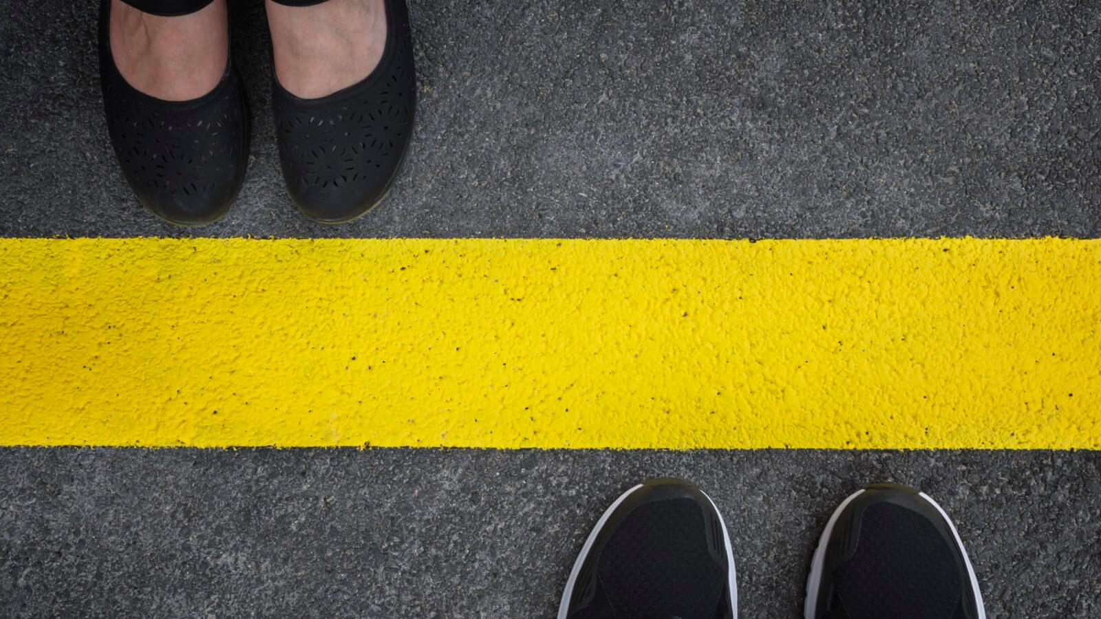 Legs of a couple standing opposite each other